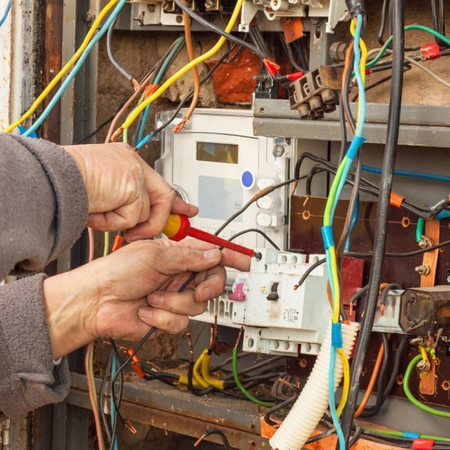 An Electrician Adjusts Wiring